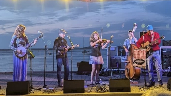 Four musicians on stage with instruments